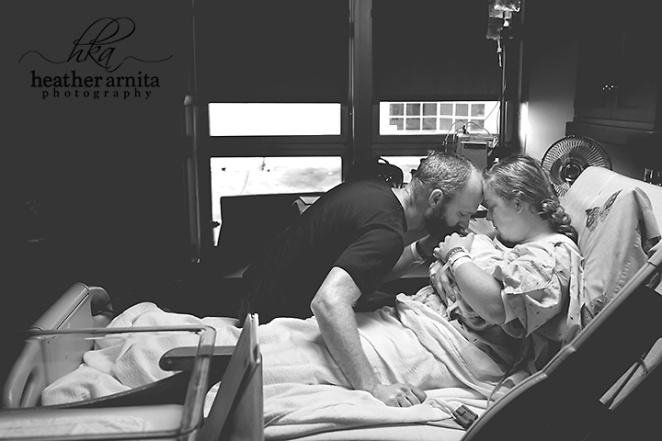 mom and dad with newborn in hospital