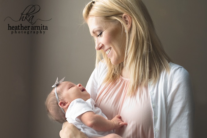 newborn lifestyle session mom smiling at baby